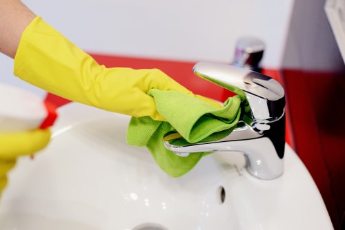 Team member using safe cleaning procedures in a domestic property